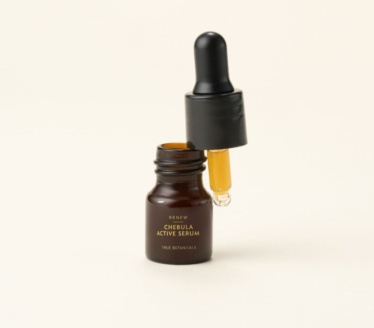 Chebula Active Serum bottle with dropper on a beige background
