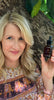 Laura Dern holding Renew Pure Radiance Oil
