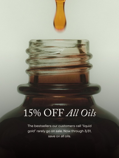 Glass bottle with a dropper and text overlay about a sale on oils.