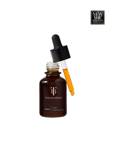 True Botanicals Renew Pure Radiance Oil in a deep amber glass dropper bottle with a black rubber bulb top and gold logo, shown on a transparent background with a New You Beauty Awards 2022 Winner badge.