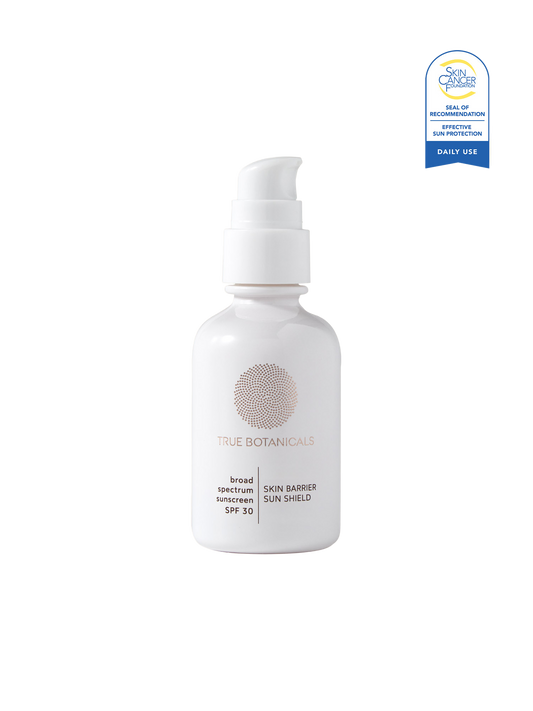 White bottle of True Botanicals sunscreen with a blue label on a white background