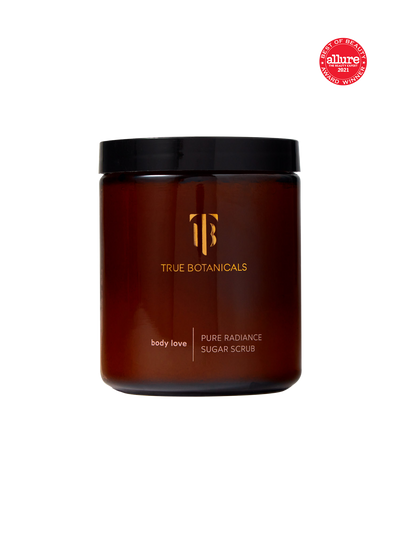 Brown jar of Pure Radiance Sugar Exfoliating Body Scrub from True Botanicals with black lid on a white background