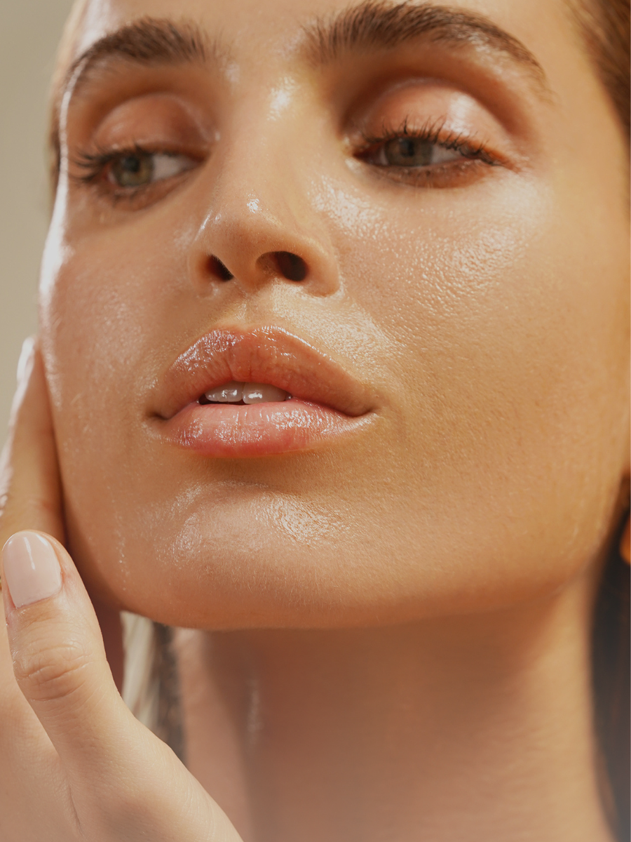 This image features a close-up of radiant, dewy skin, emphasizing hydration and a healthy glow. The focus on smooth texture and luminous complexion perfectly aligns with True Botanicals' commitment to effective, nourishing skincare.