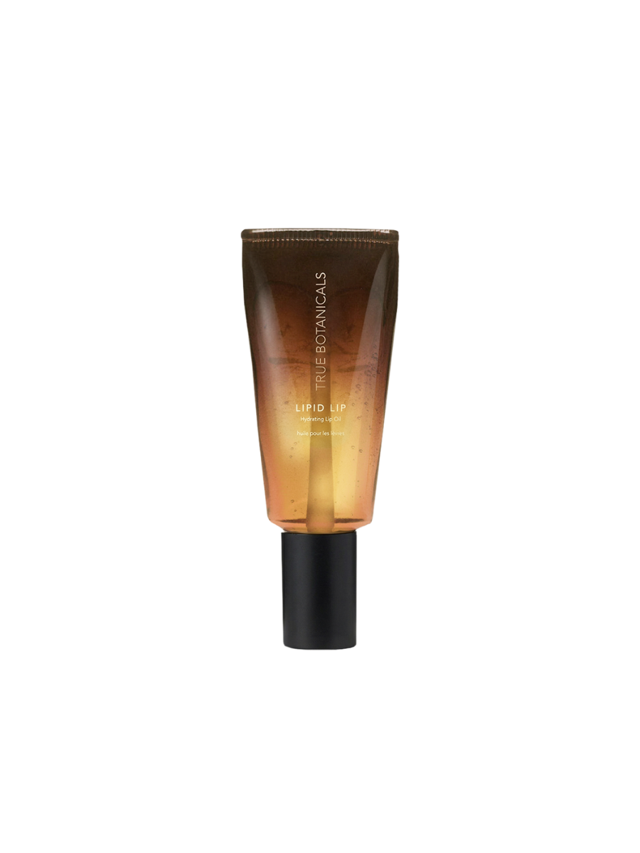 True Botanicals Lipid Lip Hydrating Lip Oil in a translucent tube with a warm amber-to-gold gradient and a matte black applicator cap.