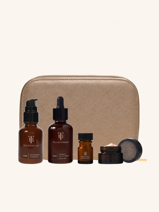 Skincare product set with bottles and a pouch on a biege background
