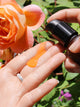 Renew Repair Nightly Treatment with orange goop against nature and flowers True Botanicals - Thumbnail Image